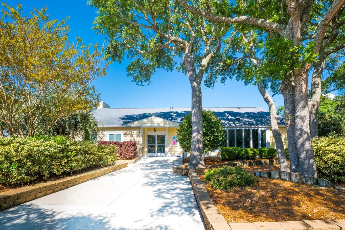 A welcoming view of the resort’s entrance, framed by mature trees and a landscaped garden. The inviting pathway and communal atmosphere suggest a gateway to both relaxation and adventure, capturing the spirit of arrival and exploration.